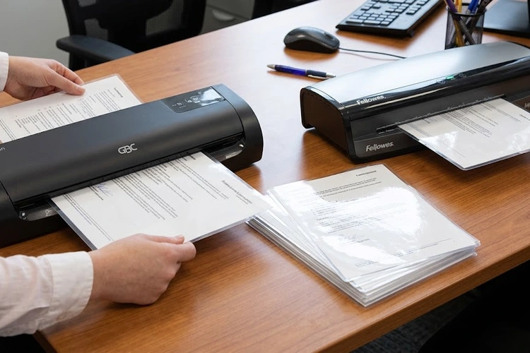 GBC vs Fellowes laminator side by side comparison on a desk