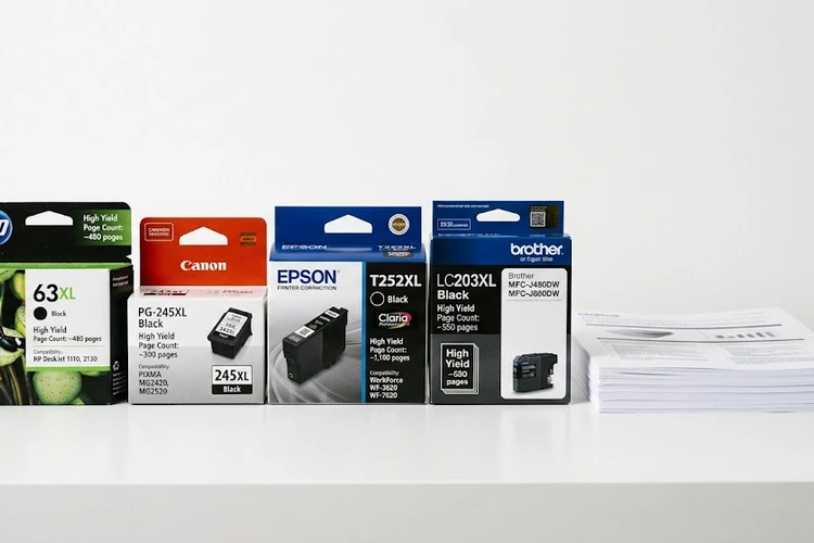 ink cartridge next to printed pages showing how many pages does an ink cartridge print