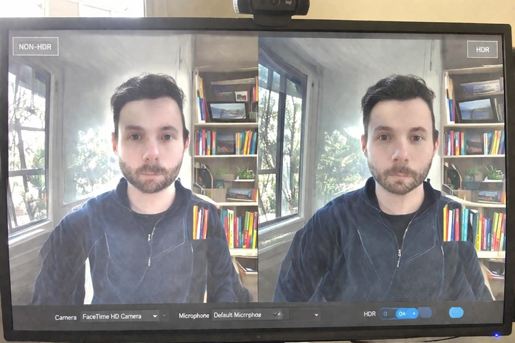A webcam preview split into two halves on a monitor — one side showing a washed-out non-HDR image near a bright window, the other showing a balanced HDR image with detail in both highlights and shadows.